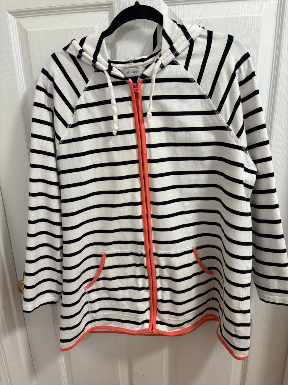 CJ Banks white and black striped zip-up hoodie features a vibrant coral trim